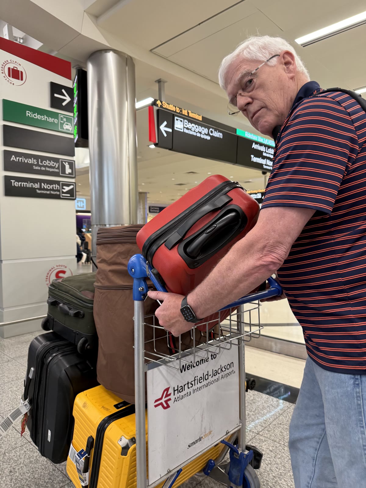 Scott carrying our luggage at Atlanta airport